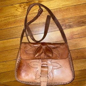 Tan 100%leather bag . With flower detailing and stitching